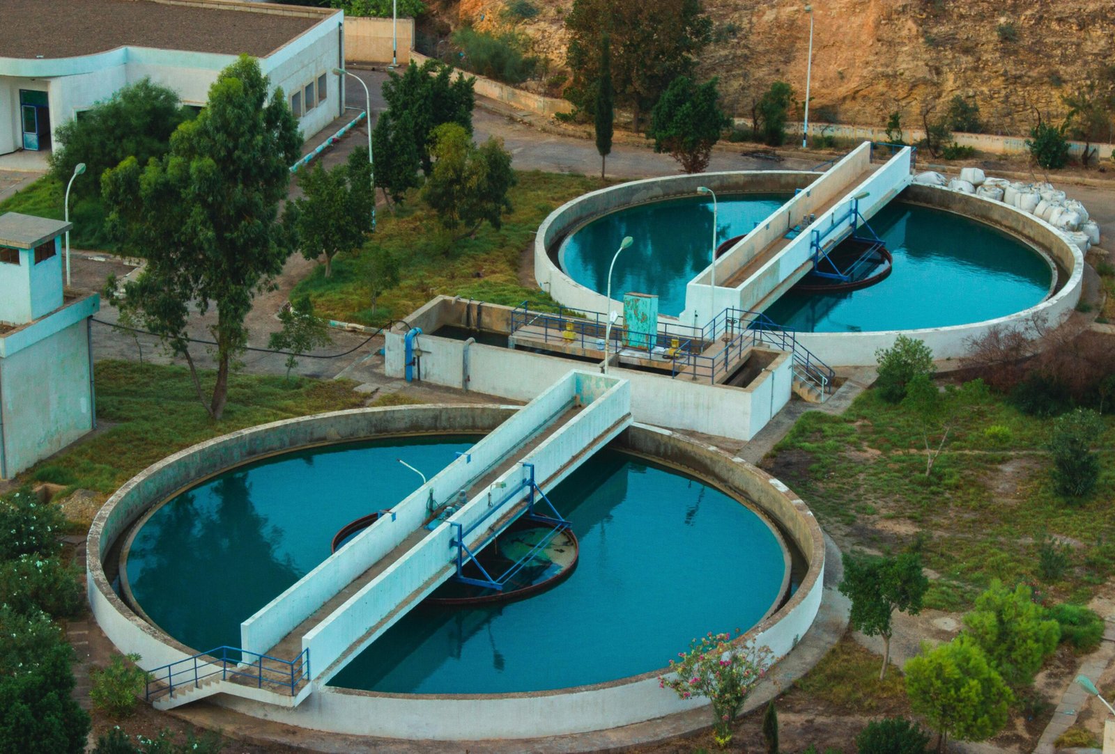 Drone shot of an advanced water purification plant surrounded by trees.